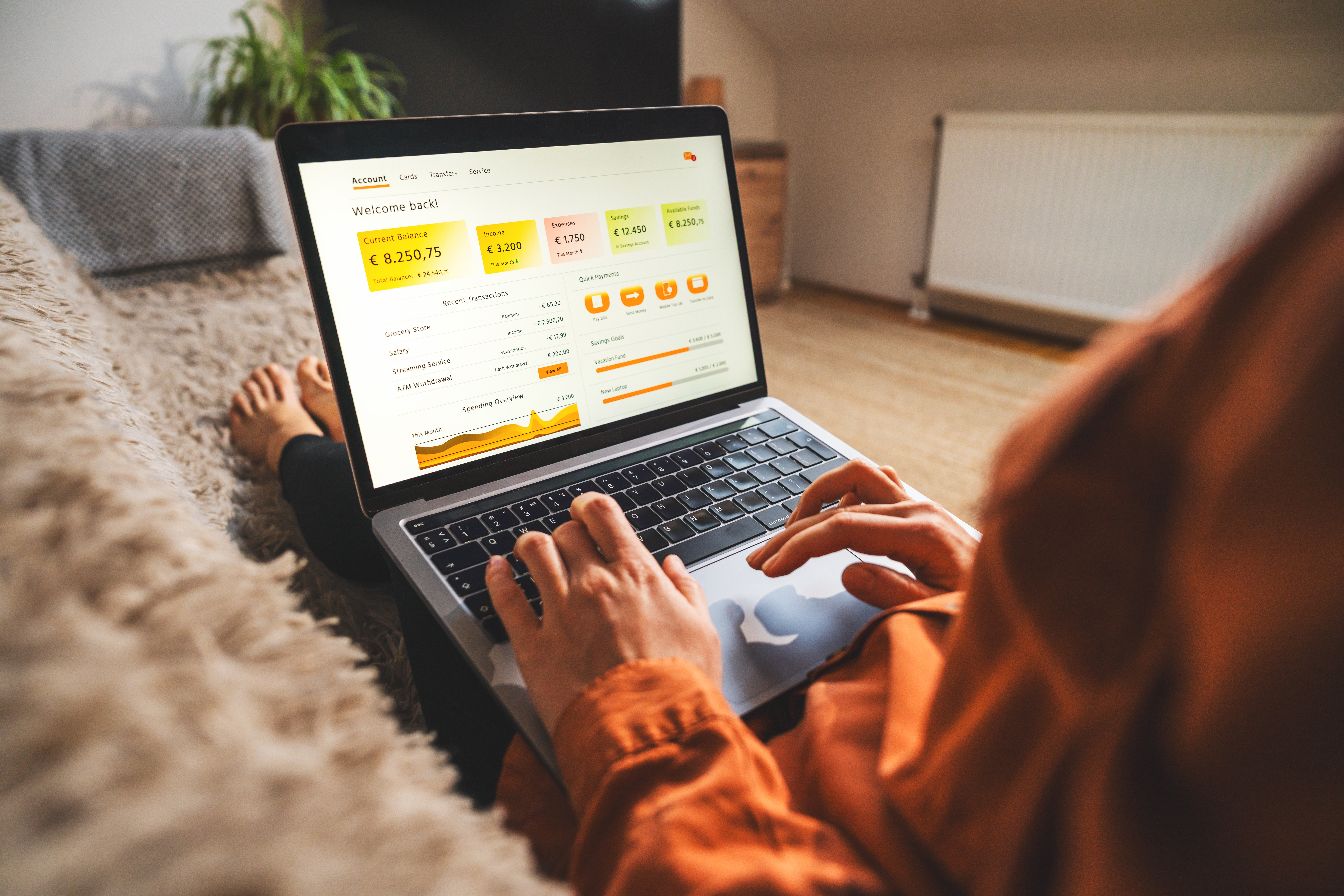 Woman using a laptop for online banking and personal finance management at home.